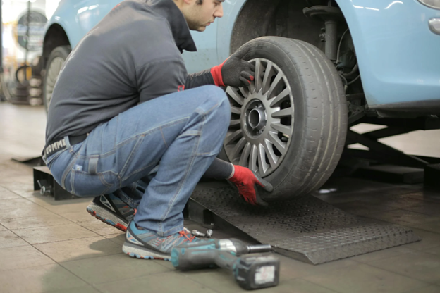 A car mechanic repairing a tire